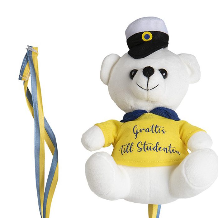 Vit nalle med studentmössa och gul tröja med text i blått "grattis till studenten"