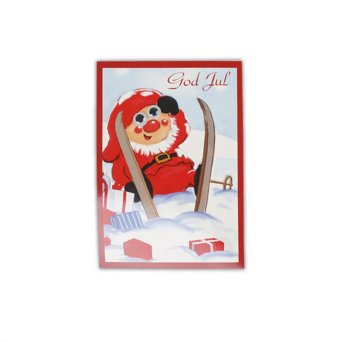 Ett roligt vykort, julkort där figuren har rörliga ögon. Tomte som ramlat i skidbacken